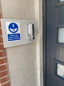 Hand sanitiser station outside an entrance to Toppesfield House